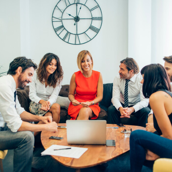 Group of people in an office space having conversation -Audit